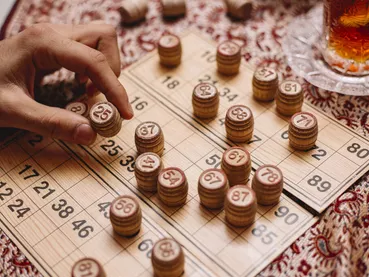 loto game man puts number tea side view